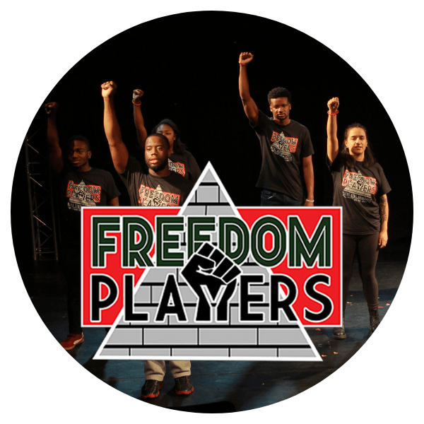 Freedom Players stand with fists raised in solidarity